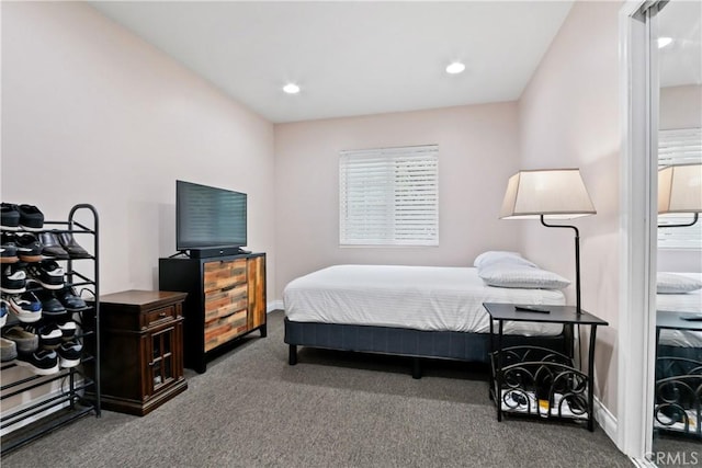 bedroom featuring dark colored carpet