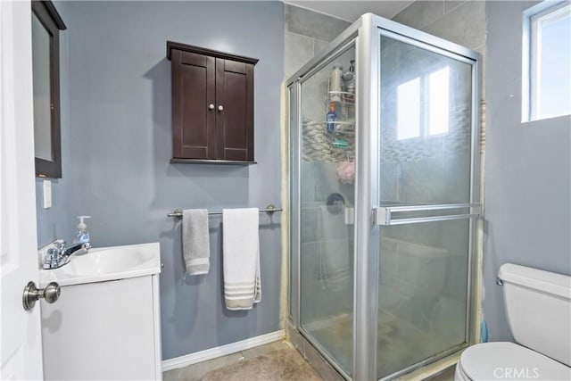 bathroom featuring vanity, toilet, and walk in shower