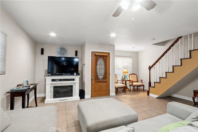 tiled living room with ceiling fan