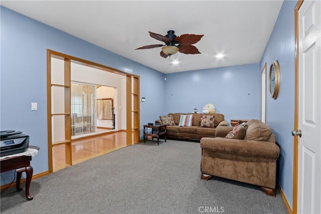 living room featuring carpet and ceiling fan