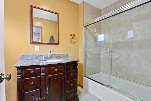 bathroom with tile patterned flooring, vanity, and enclosed tub / shower combo