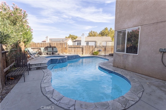 view of swimming pool featuring an in ground hot tub and a patio area