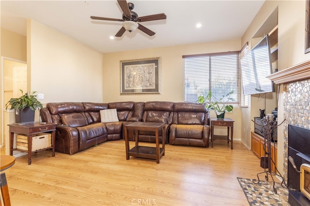 living room featuring light hardwood / wood-style floors and ceiling fan