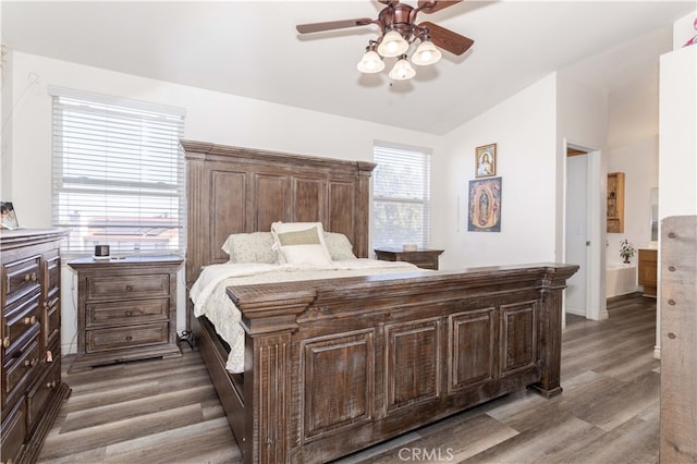 bedroom with connected bathroom, ceiling fan, lofted ceiling, and light hardwood / wood-style flooring