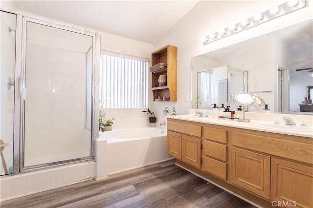 bathroom with vanity, vaulted ceiling, separate shower and tub, and wood-type flooring