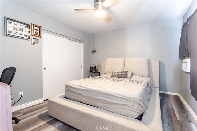 bedroom with a closet, ceiling fan, and hardwood / wood-style floors