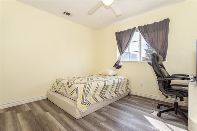 bedroom with wood-type flooring and ceiling fan