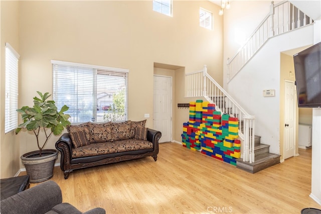 living room featuring hardwood / wood-style floors and a high ceiling