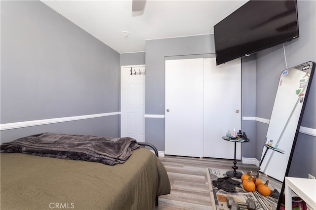 bedroom with ceiling fan and light hardwood / wood-style flooring