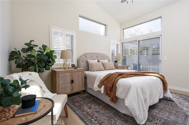 bedroom featuring ceiling fan, high vaulted ceiling, hardwood / wood-style flooring, and access to exterior