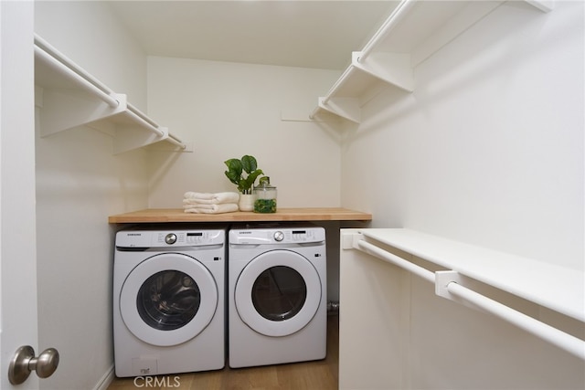 clothes washing area featuring washing machine and dryer and dark hardwood / wood-style flooring