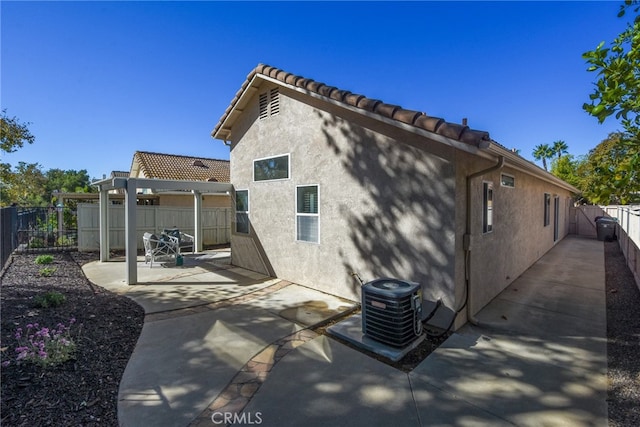 back of property featuring a patio area and cooling unit