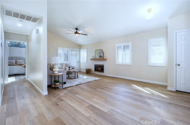 unfurnished living room with lofted ceiling, light wood-type flooring, and ceiling fan