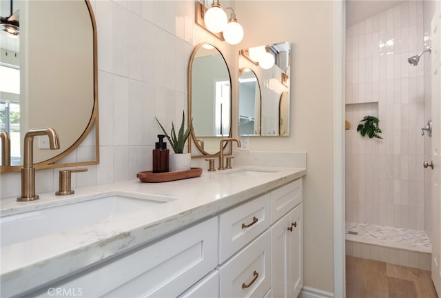 bathroom with vanity and a tile shower