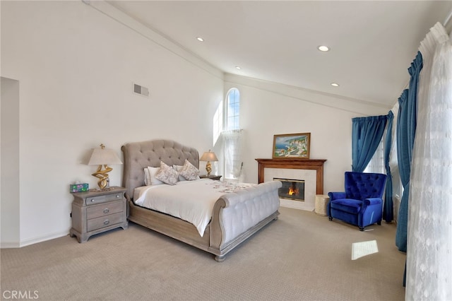 bedroom featuring light colored carpet and high vaulted ceiling