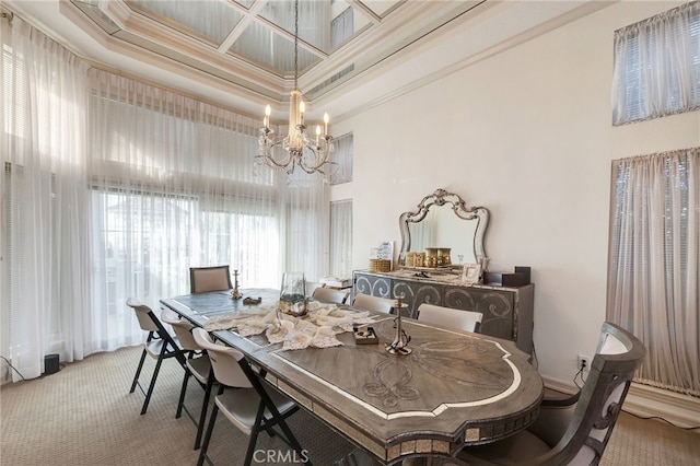 carpeted dining room featuring coffered ceiling, a tray ceiling, ornamental molding, a notable chandelier, and a towering ceiling