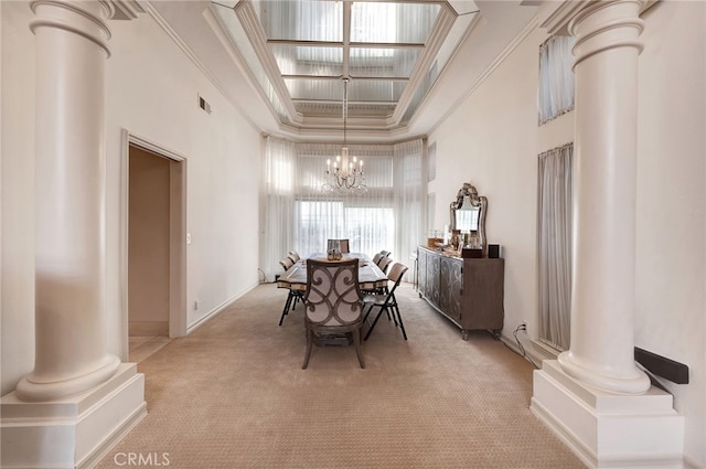 carpeted dining area with crown molding, a notable chandelier, a high ceiling, and a tray ceiling