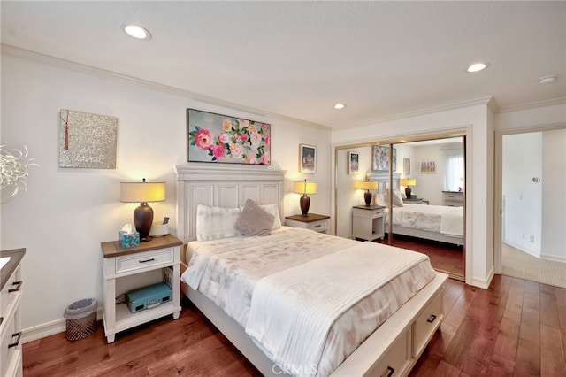 bedroom with crown molding, dark hardwood / wood-style floors, and a closet