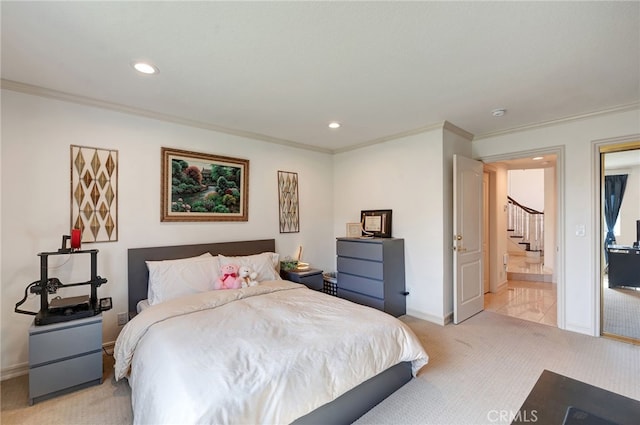 bedroom featuring connected bathroom, light carpet, and ornamental molding