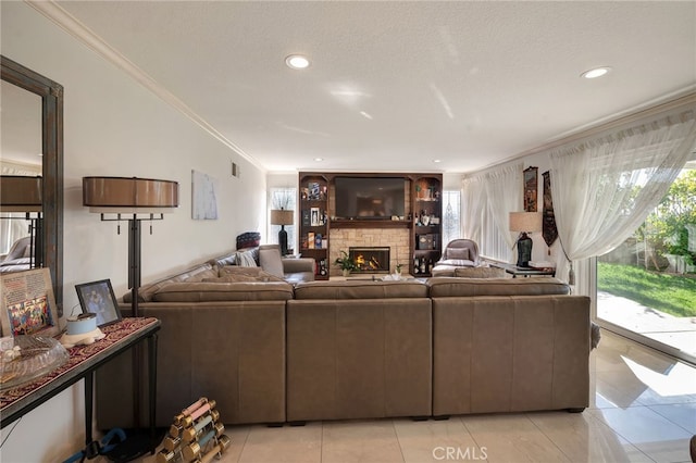 tiled living room featuring ornamental molding, a textured ceiling, and a fireplace