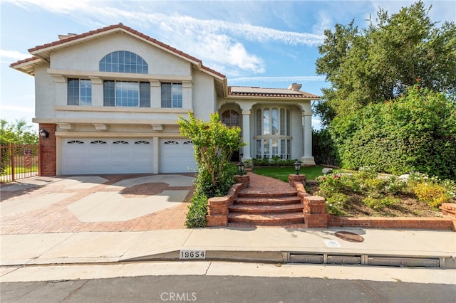 mediterranean / spanish-style house with a garage