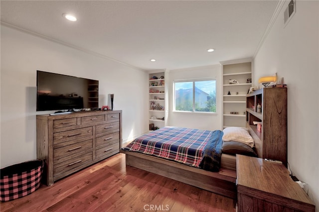 bedroom featuring crown molding and hardwood / wood-style flooring