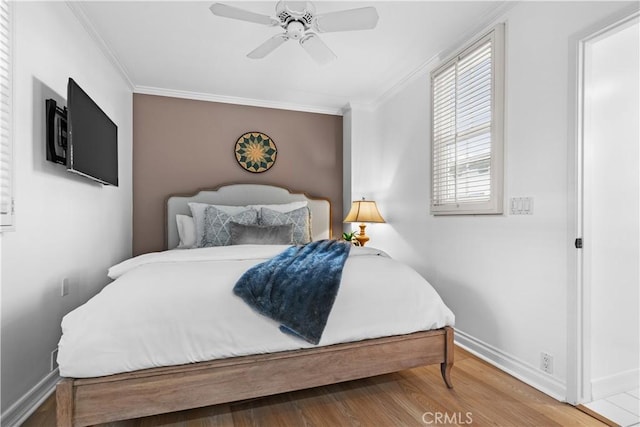 bedroom featuring wood-type flooring, ceiling fan, and ornamental molding