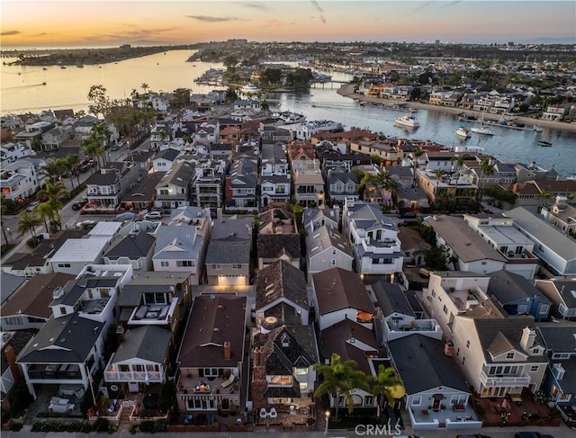 aerial view at dusk with a water view