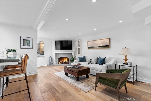 living room featuring light wood-type flooring and crown molding