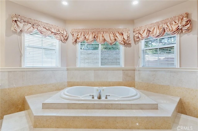 bathroom featuring a relaxing tiled tub