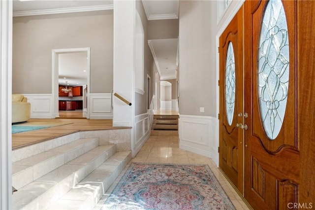 foyer entrance featuring ornamental molding and light tile patterned floors