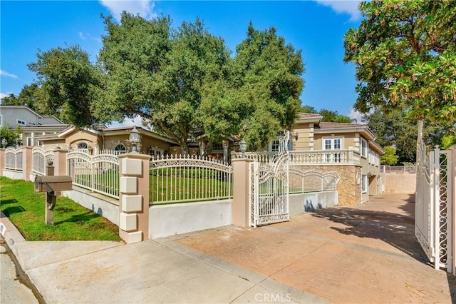 view of gate with a fenced front yard