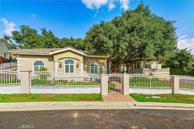 view of front of property featuring a fenced front yard and stucco siding