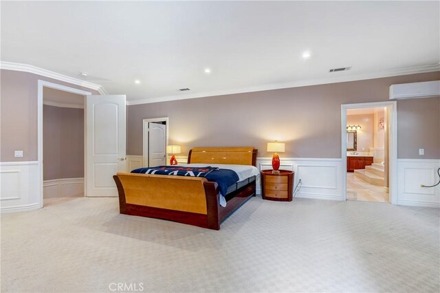 carpeted bedroom with ensuite bathroom, ornamental molding, and a wall unit AC