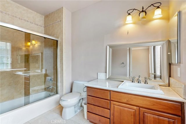 full bathroom featuring toilet, vanity, bath / shower combo with glass door, and tile patterned flooring