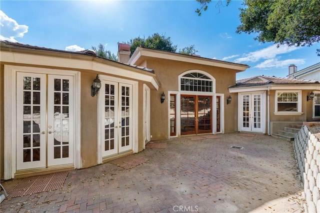 rear view of property with french doors