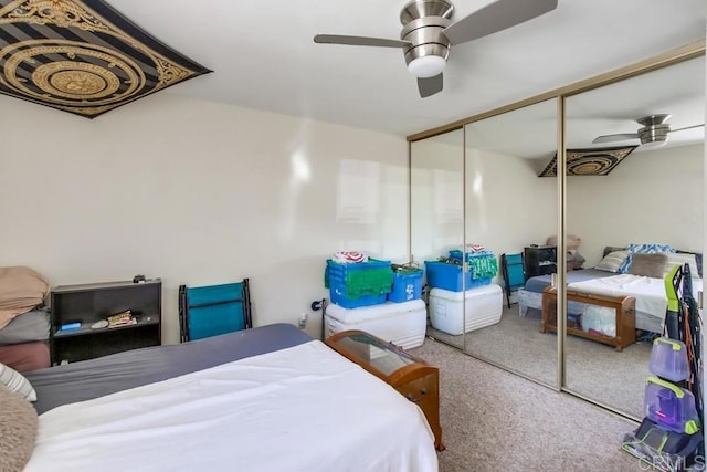 carpeted bedroom featuring a closet and ceiling fan