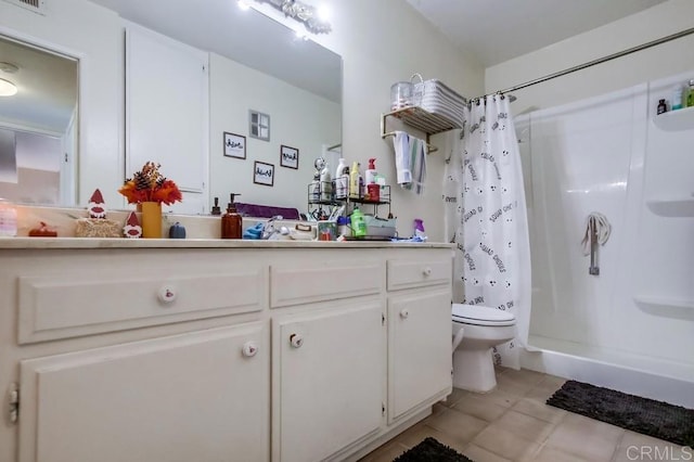 bathroom with vanity, walk in shower, toilet, and tile patterned floors