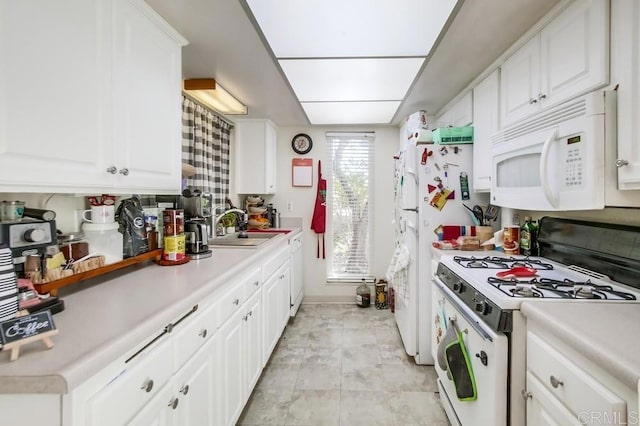 kitchen featuring sink, white cabinetry, and white appliances