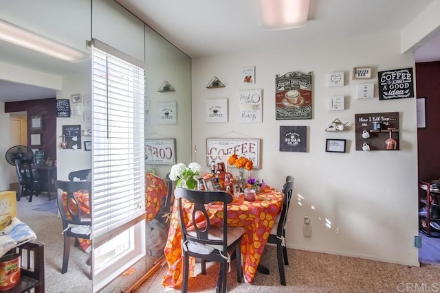 dining space featuring carpet