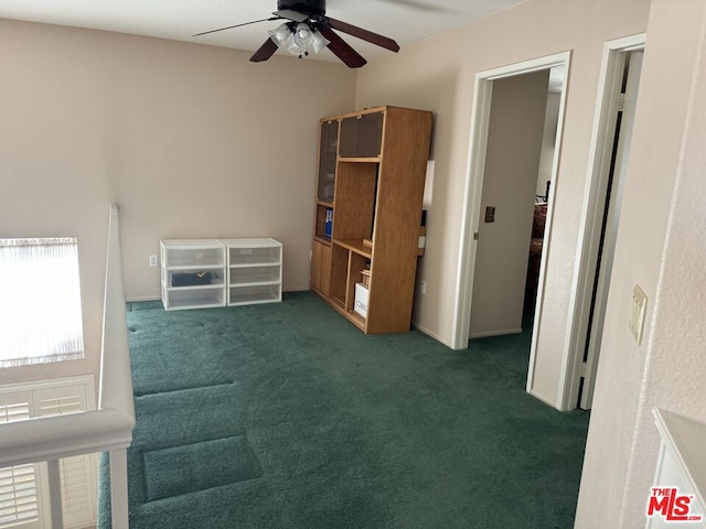 interior space with ceiling fan and dark colored carpet