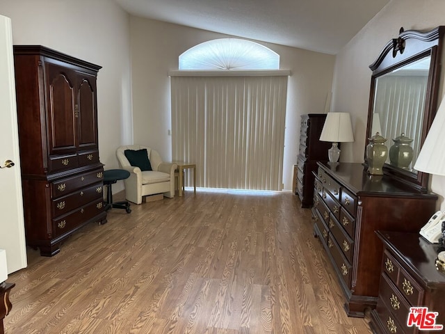 sitting room featuring hardwood / wood-style flooring and vaulted ceiling