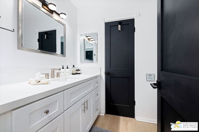 bathroom with vanity and wood-type flooring