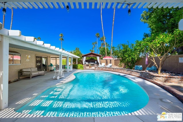 view of swimming pool with a gazebo and a patio area