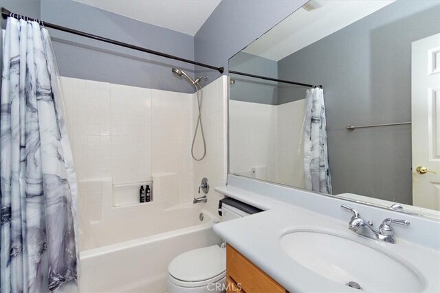 full bathroom featuring vanity, toilet, and shower / bathtub combination with curtain