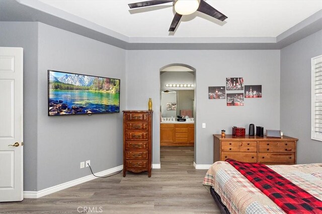 bedroom featuring ceiling fan, wood-type flooring, and connected bathroom