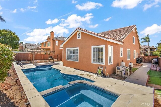 view of pool with a patio area and an in ground hot tub