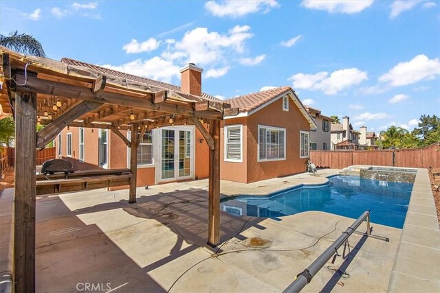 view of pool with an in ground hot tub and a patio