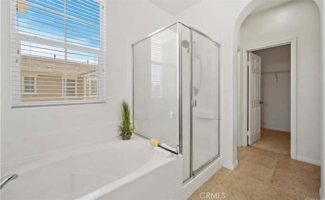 bathroom with tile patterned floors and independent shower and bath