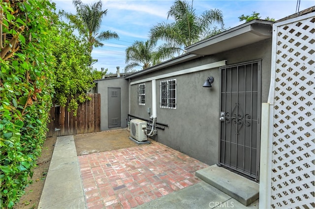 doorway to property featuring ac unit and a patio area